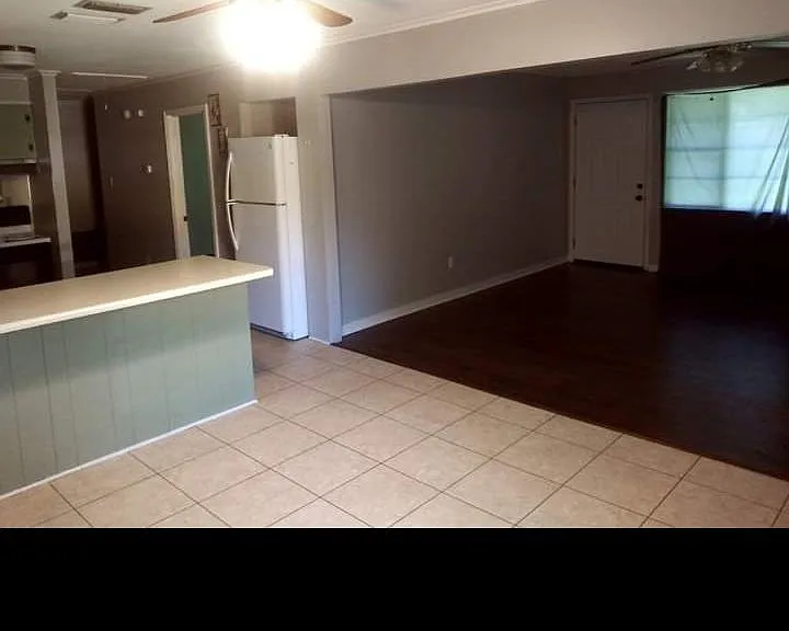 Open floor plan view (before new paint and wood flooring)