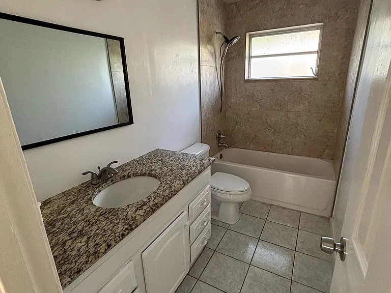 Very clean bathroom with full tub and shower.