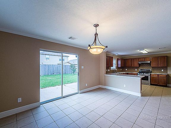 This dining/breakfast area offers plenty of room to fit even the largest dining table! Open to the k
