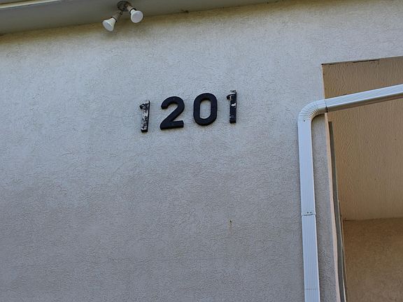 Building number is hidden behind evergreen trees.