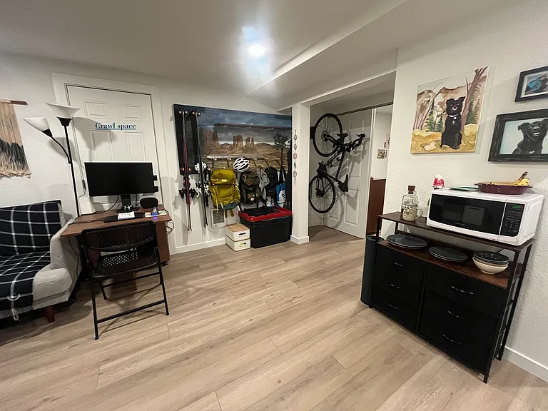 Living space - (locked crawlspace pictured behind desk)