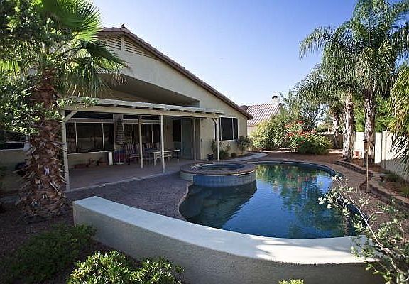 The pool area and lucscious back yard