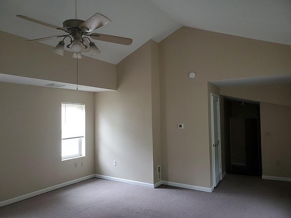 Living room has vaulted ceiling with lots of light