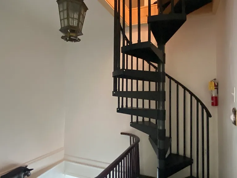 Entry hall with spiral to upper level den or family room.