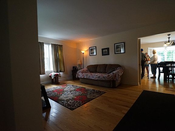 LIVING ROOM LOOKING INTO DINING ROOM AND 3 SEASON PORCH JUST