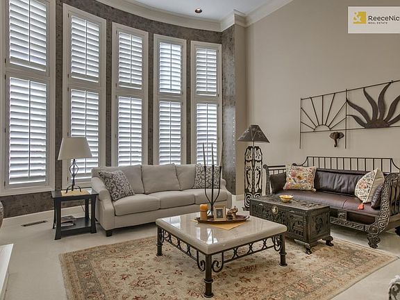 Formal Living room with wall of windows and fireplace.