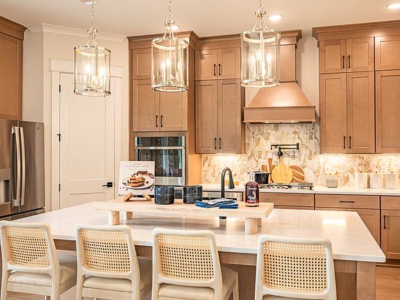 Full kitchen layout with large extended island and beautiful ceiling height cabinetry