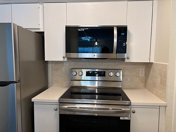 Brand new appliances and freshly pained kitchen cabinets