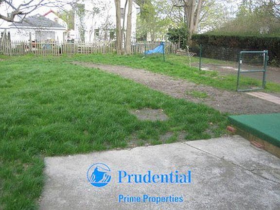 Large, private backyard with small concrete patio. 