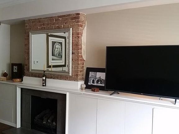 Perfectly designed built-ins, exposed brick, ventless gas fireplace.