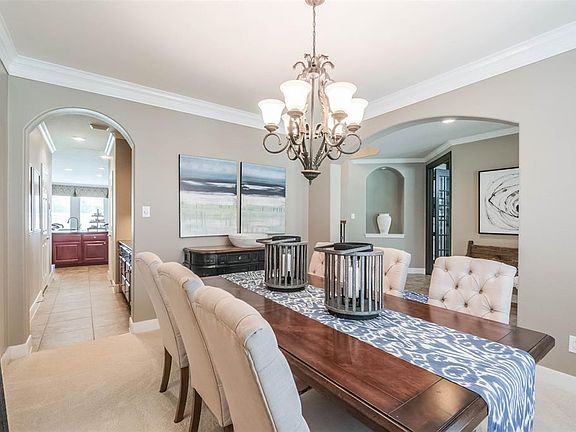 The formal dining room is located to the left of the foyer and is connected to the kitchen by a convenient butler's pantry.