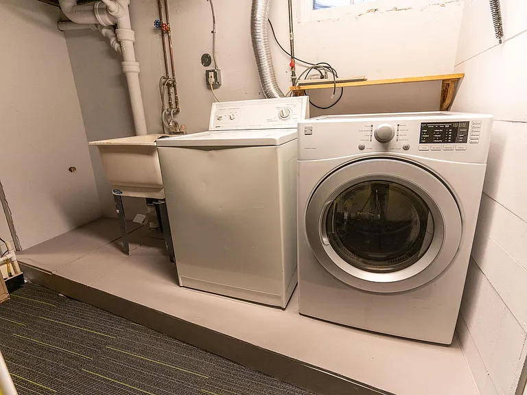 Washer & Dryer along with a large wash basin style sink.