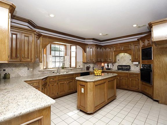 Fabulous island kitchen is updated with gorgeous granite counters.