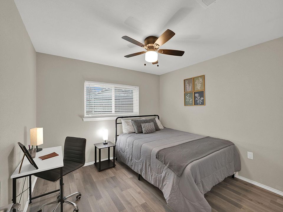 Bedroom 6 provides a queen bed and workspace.