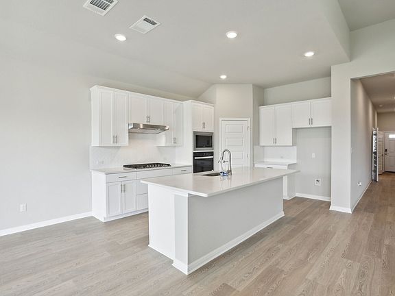 Cook your favorite meal in this beautiful white kitchen.