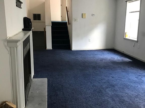 Living room with steps to kitchen and second bedroom/bathroom