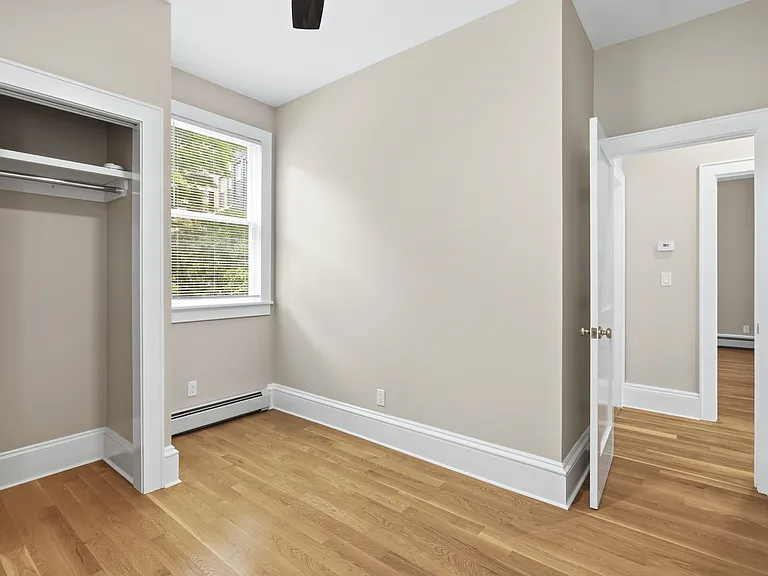 The second bedroom is a cozy space with plenty of natural light, storage, and can also be used as an office.