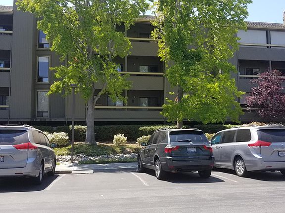 View from parking lot. Second story unit with large patio.