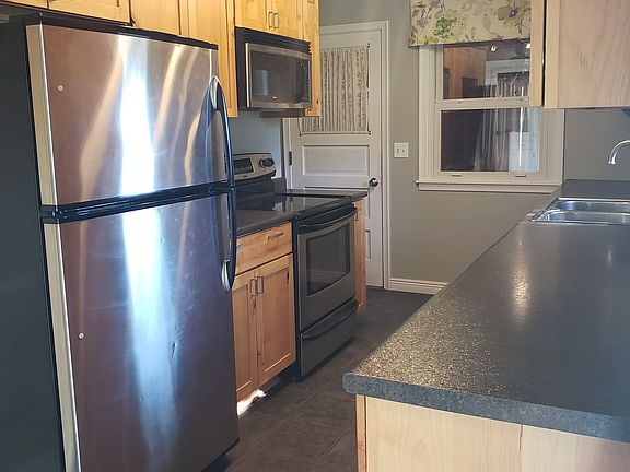 Kitchen, and door to three season porch + garage.