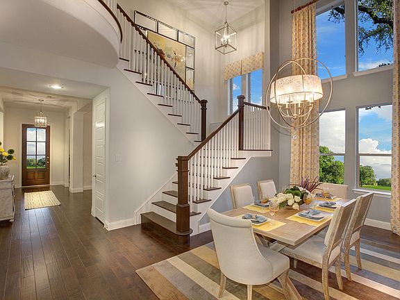 The Tiana dining room featuring hardwood floors and a dramatic staircase
