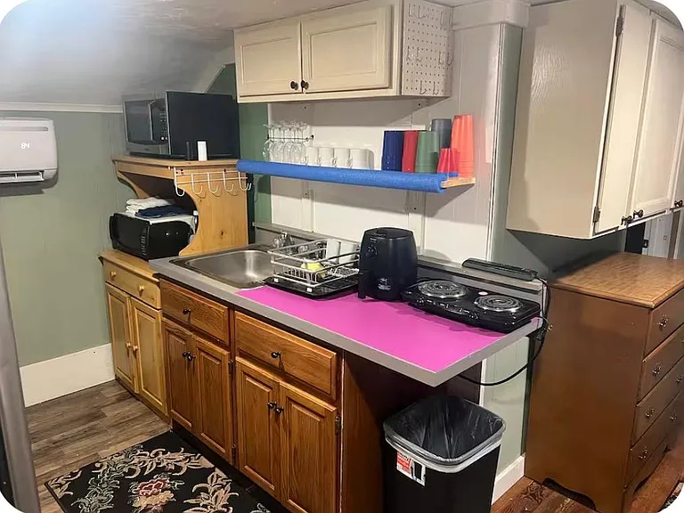 2nd floor kitchen with microwave, electric cook top, hot air fryer, desktop oven, blender, cups dishes utensils, coffee makers, compact fridge. Most everything you'll need