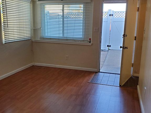 laminate and tile throughout. Premium vinyl blinds in the kitchen and living room.