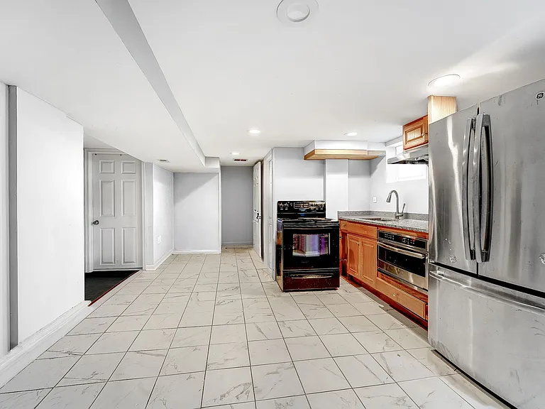 Lower level has microwave convection oven, large refrigerator-freezer, cabinets sink and disposal.