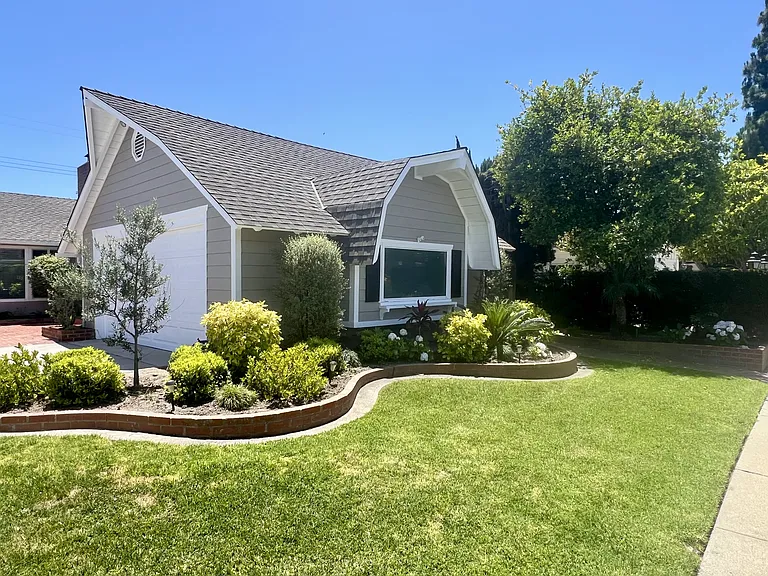 Garage, driveway, landscaping, mature lemon tree