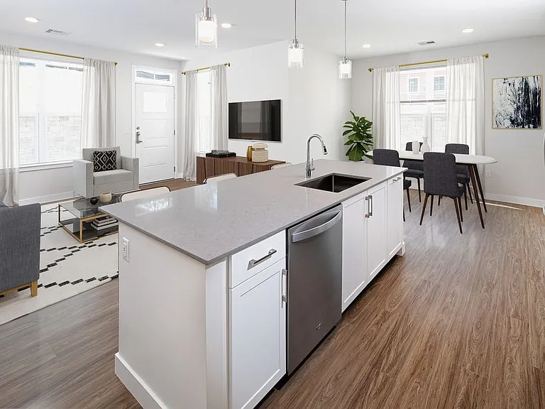 Phase II Renovated Package I apartment kitchen, dining, and living room with hard surface flooring
