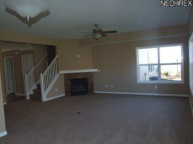 Great room with gas fireplace and wall of windows looking at Lake Erie!