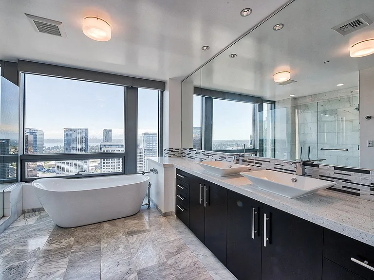 Spa-inspired master bathroom with soaking tub, glass-enclosed shower and breathtaking PNW views