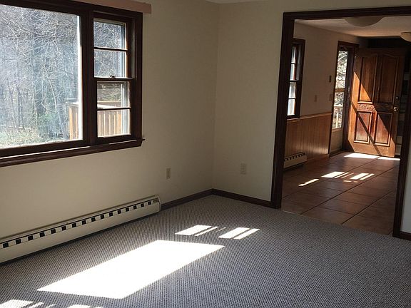 Large Open Living Rm with afternoon sunshine -Opens to Kitchen