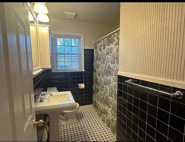 Hallway Bath with traditional black and white tile