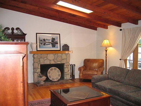 Charming hi-beamed, tongue'n groove ceiling living room with fireplace