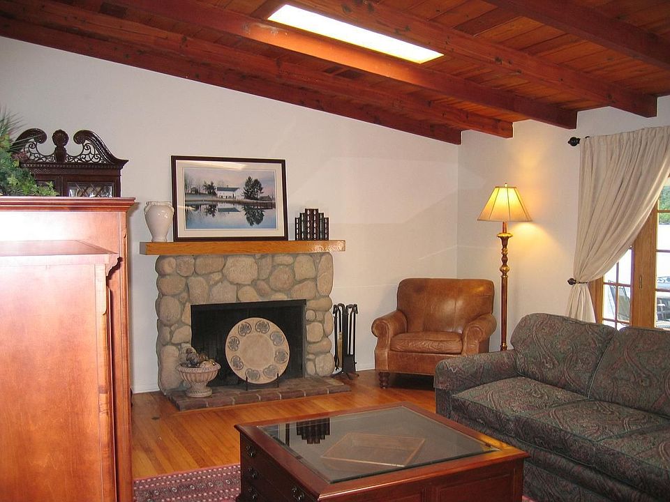 Charming hi-beamed, tongue'n groove ceiling living room with fireplace