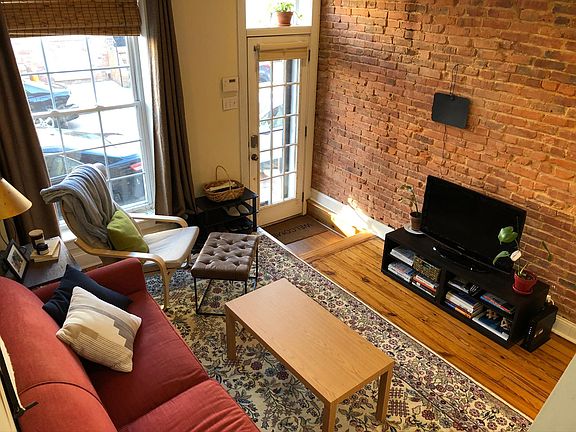 Living room with lots of exposed brick