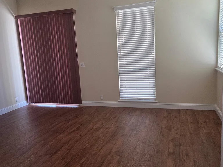 Large master bedroom offers ceiling fan, sitting area, sliding glass door opens to the backyard, light and bright