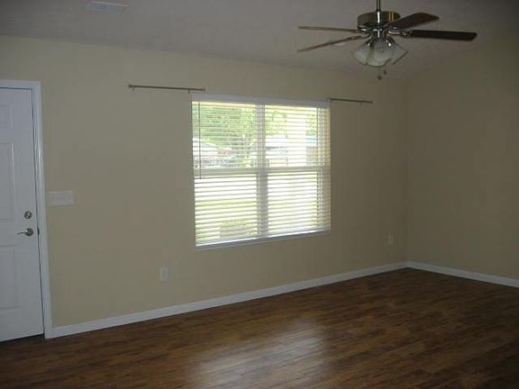 Family Room with Vaulted Ceiling and Lighted Ceiling Fan