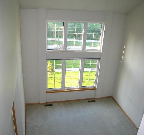 Living room w/ high ceilings and windows