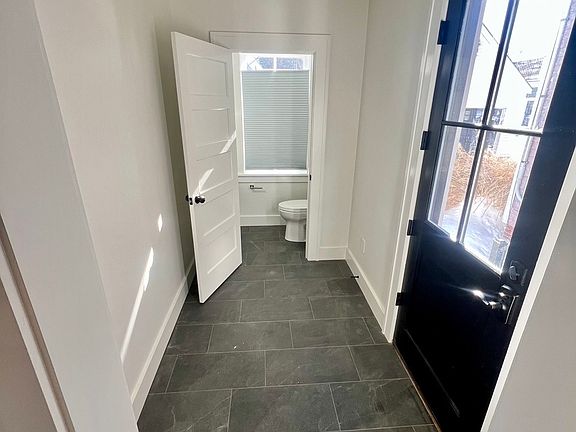 Side entry into heated floor mud room with access to first floor powder room.