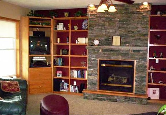 Built In Shelving Surrounds Fieldstone Fireplace