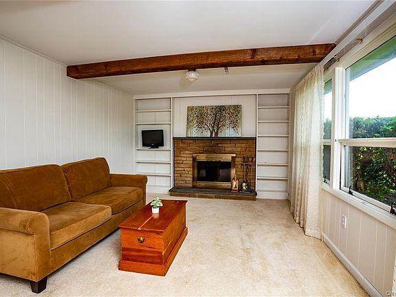You be welcomed by the family room when you enter the home. This is one of 2 woodburning fireplaces...