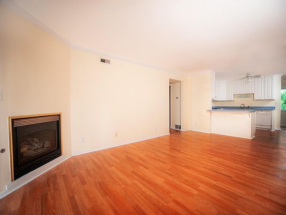 Living room with fireplace facing kitchen