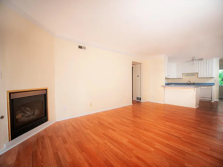 Living room with fireplace facing kitchen