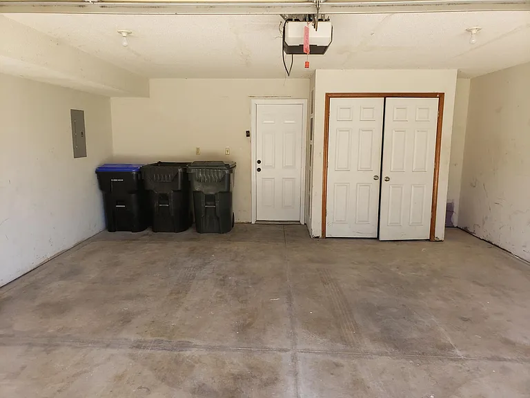 View of garage - water tank and furnace located in garage closet