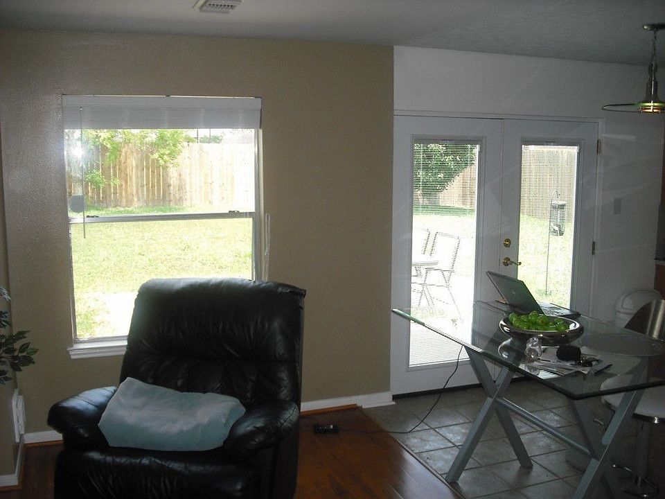 Very sunny living room/den and kitchen