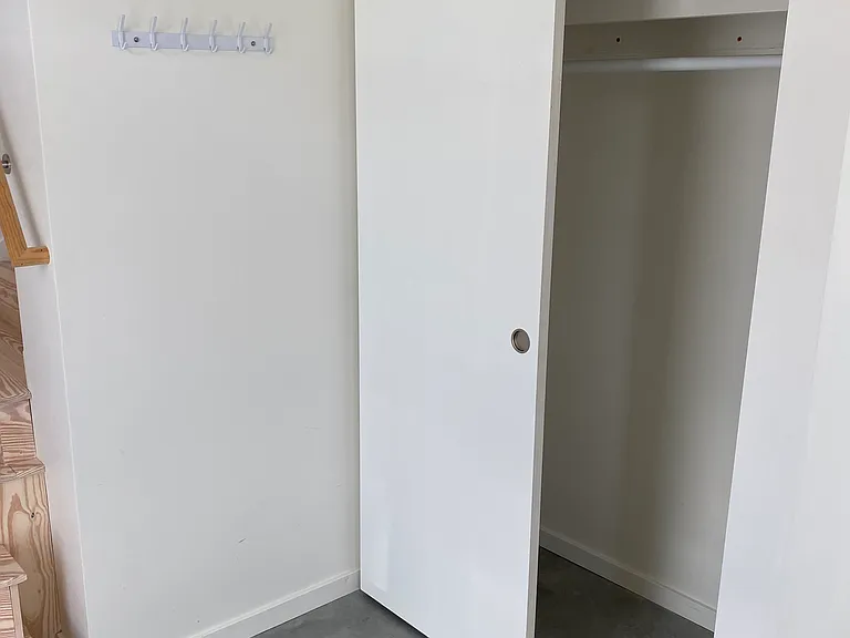 Entryway closet with bar and shelf. Two doors slide both ways.