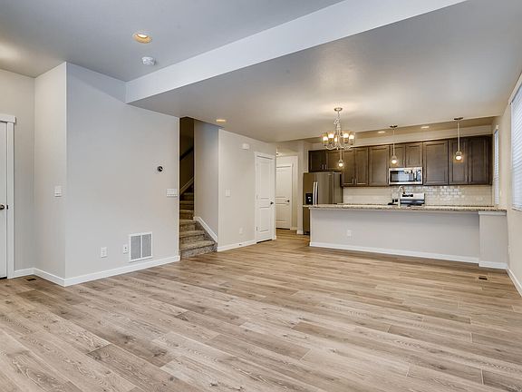 dining and kitchen from living room area. Powder bath at stair landing. Large kitchen island