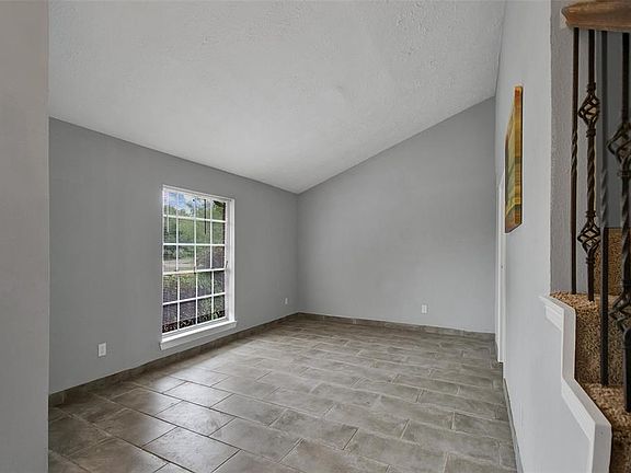 Formal dining room with plenty of natural light and tile floors. All interior walls recently painted.