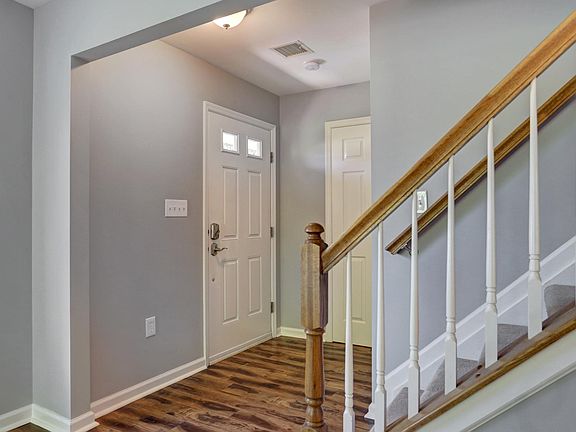 Entrance with a coat closet and powder bathroom